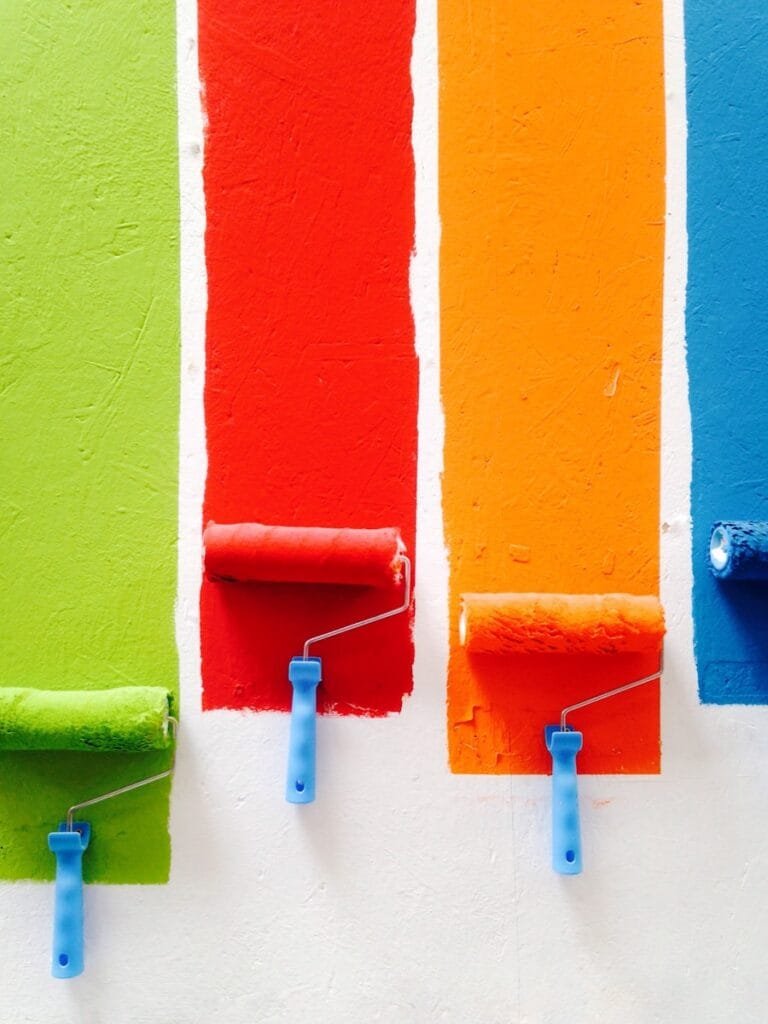 Photo by David Pisnoy four orange, green, blue, and red paint rollers